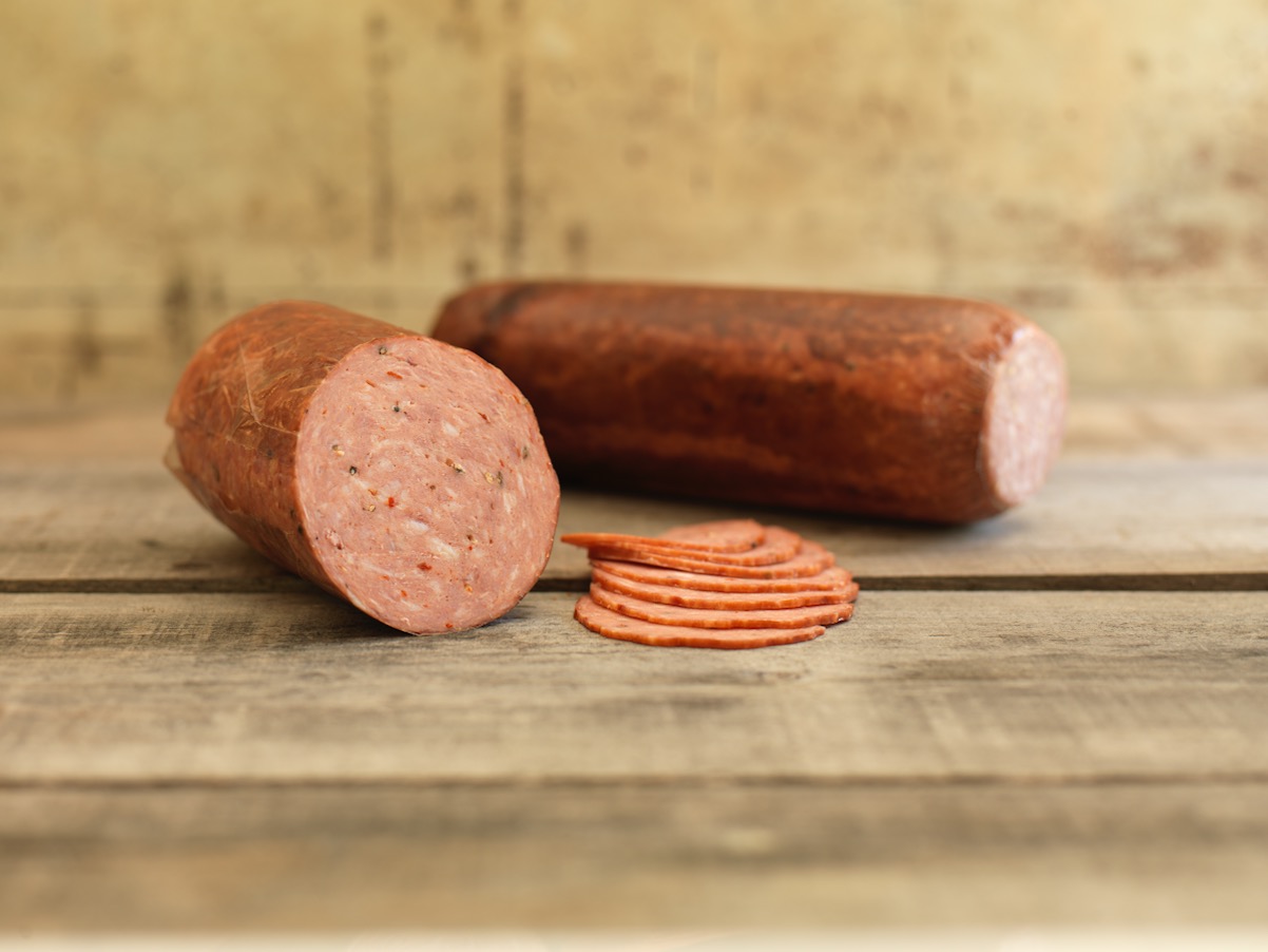 Northern Italian salami with sliced pieces on a wooden surface